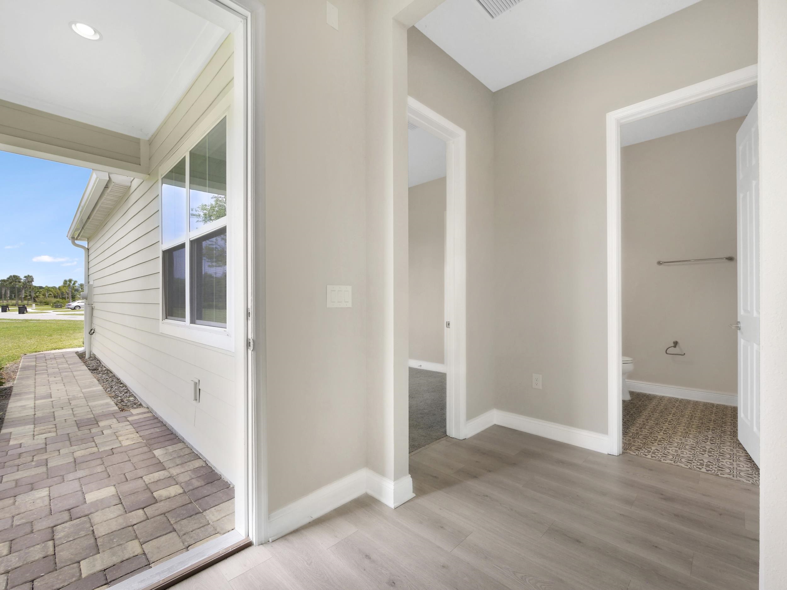 471 Rum Runner Way St. Johns, FL 32259 - Photo 18 of 42 a view of a hallway with wooden floor and a bathroom
