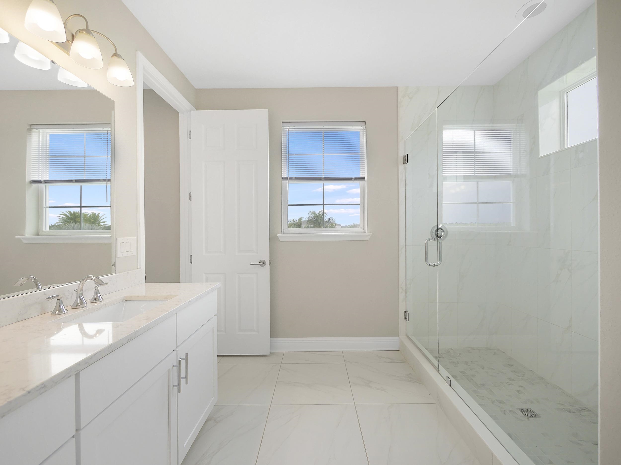 471 Rum Runner Way St. Johns, FL 32259 - Photo 26 of 42 a bathroom with a granite countertop sink a mirror and a bathtub