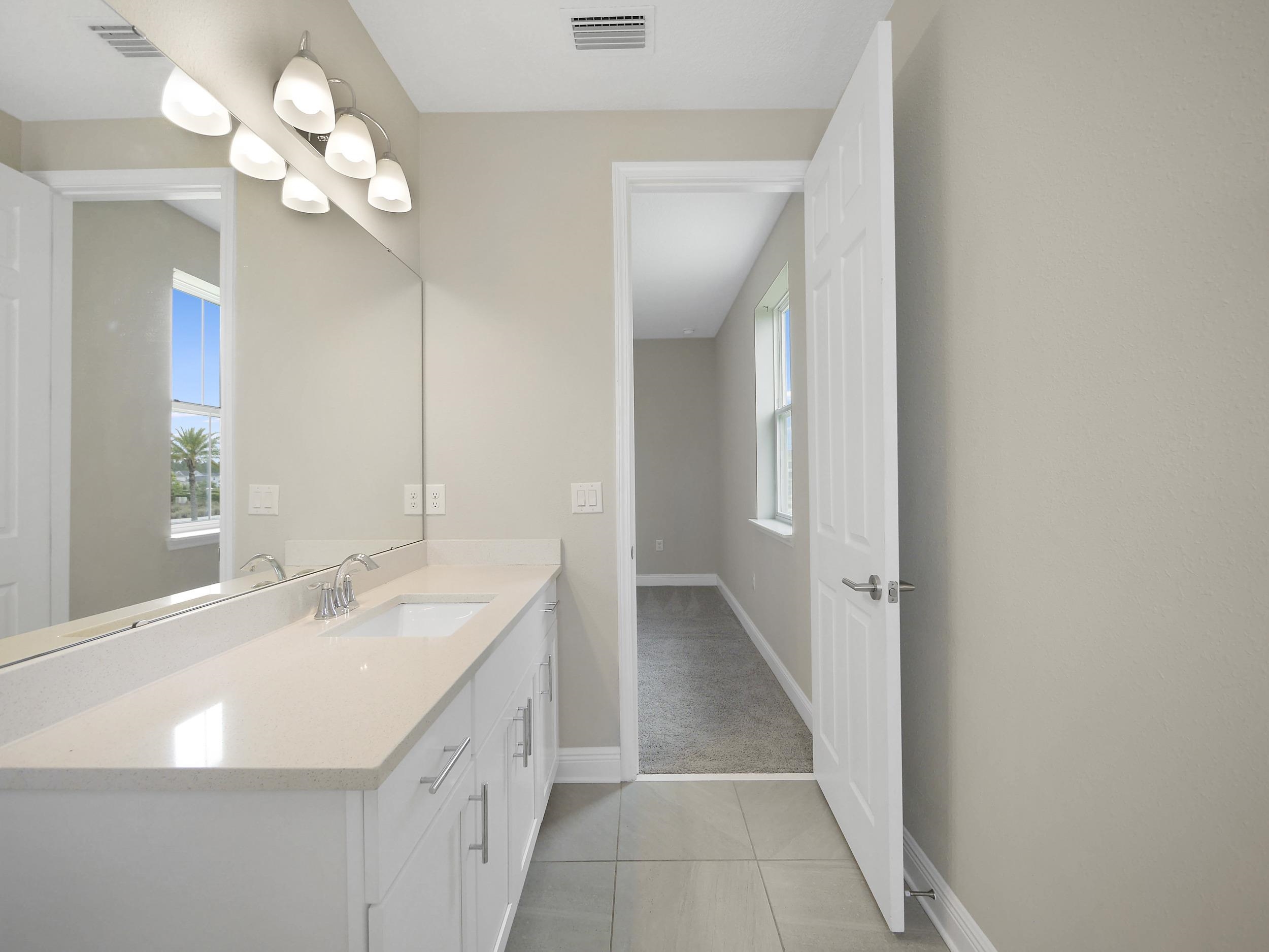 471 Rum Runner Way St. Johns, FL 32259 - Photo 32 of 42 a bathroom with a sink vanity and a mirror