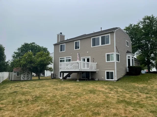 a view of a house with a yard and sitting area