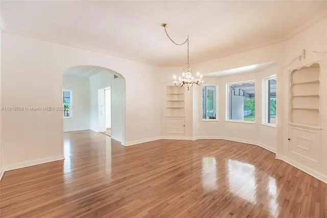 a view of a room with wooden floor and chandelier