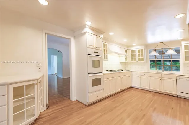 a kitchen with granite countertop cabinets a sink and a stove