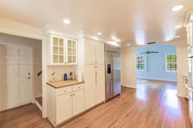 a view of a room with wooden floor and white walls