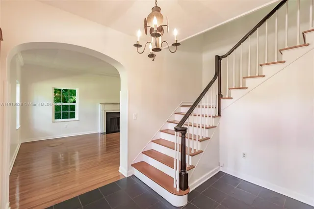 a view of empty room with wooden floor and fireplace