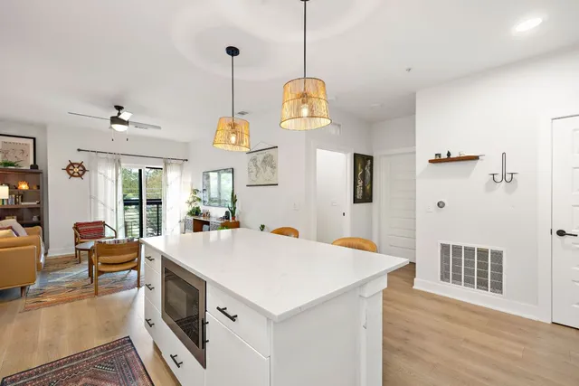 a large kitchen with sink and refrigerator