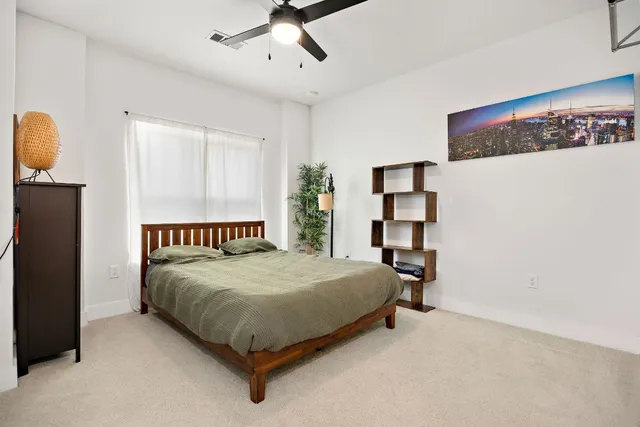 a bedroom with a bed and cabinets