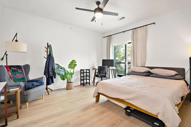 a bedroom with a bed a desk and chair