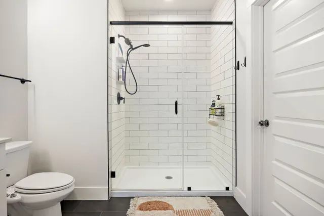 a bathroom with a shower and a toilet