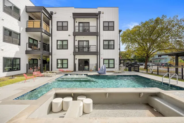 a view of a house with swimming pool and sitting area