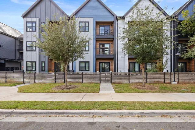 a view of a house with swimming pool next to a yard
