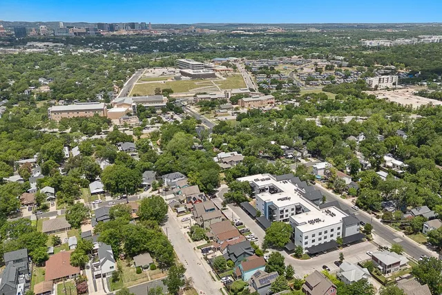 an aerial view of residential houses with outdoor space
