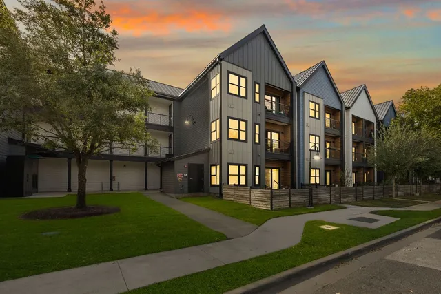 front view of a brick building next to a yard