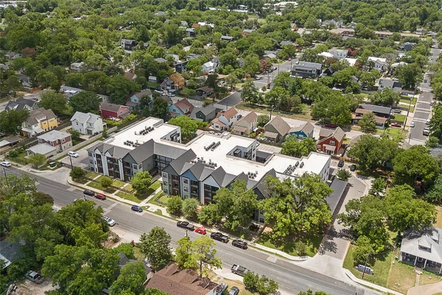 an aerial view of residential houses with outdoor space