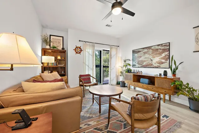 a living room with furniture and a potted plant