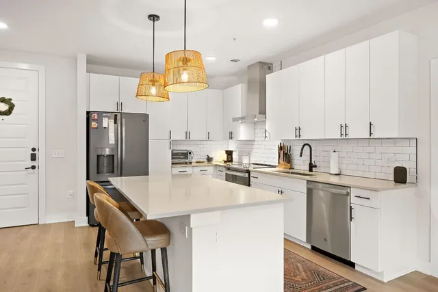 a kitchen with a center island a counter space appliances and cabinets