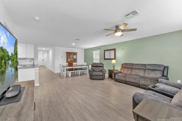 a living room with furniture and wooden floor