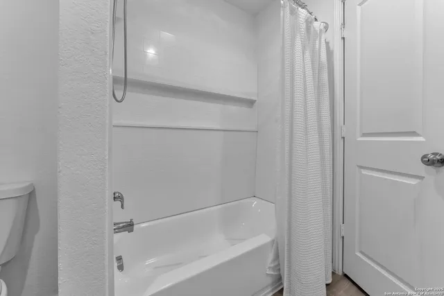 a bathroom with a tub and a sink