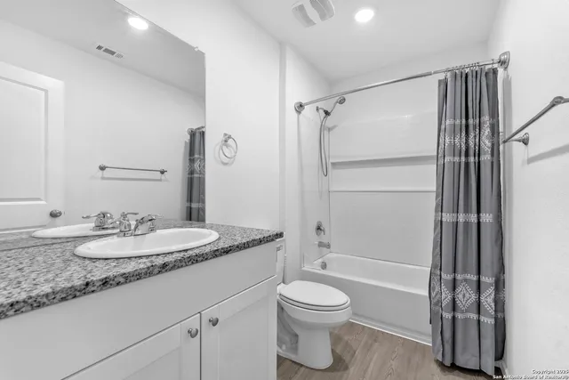 a utility room with dryer washer and a fridge