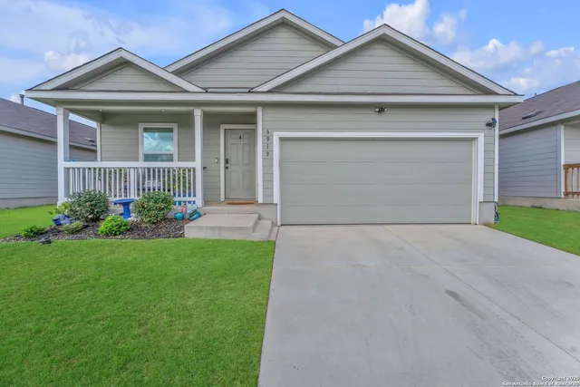 a front view of a house with a garden and plants