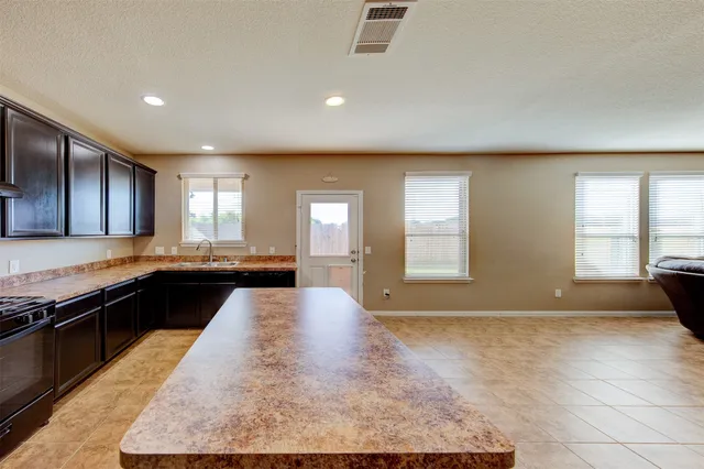 a view of a kitchen with granite countertop lots of counter top space