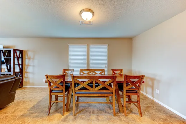 a dining room with furniture and window