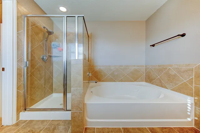 a bathroom with a bathtub and shower