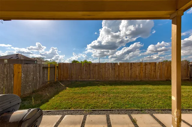 a view of a backyard of the house