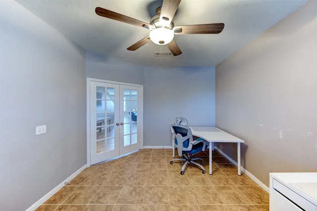 a view of a workspace with furniture and chandelier