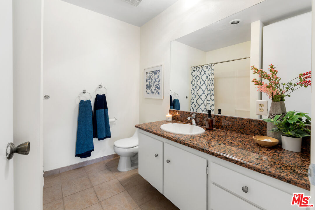 1401 Valley View Road, Unit 118 Glendale, CA 91202 - Photo 15 of 23 a bathroom with a granite countertop sink and a mirror