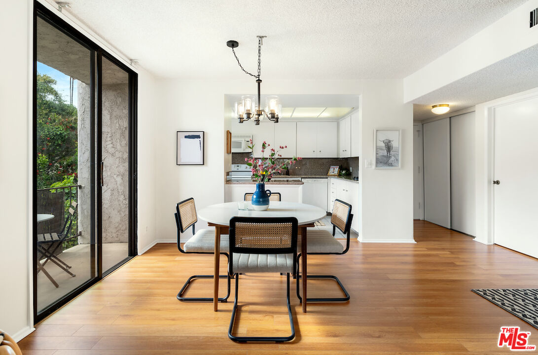 1401 Valley View Road, Unit 118 Glendale, CA 91202 - Photo 8 of 23 a dining room with furniture a chandelier and wooden floor