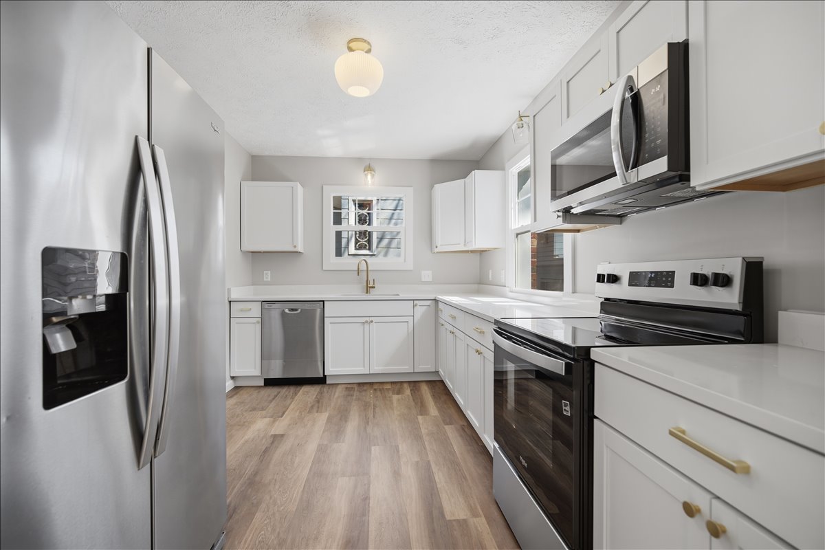 503 East Chestnut Street Bloomington, IL 61701 - Photo 2 of 24 a kitchen with stainless steel appliances a sink dishwasher a refrigerator and a stove with wooden floor
