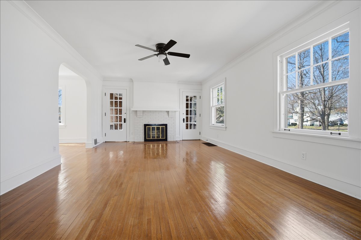 503 East Chestnut Street Bloomington, IL 61701 - Photo 5 of 24 a view of empty room with wooden floor and fireplace