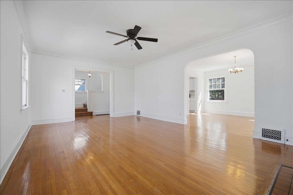 503 East Chestnut Street Bloomington, IL 61701 - Photo 6 of 24 a view of a livingroom with wooden floor and ceiling fan