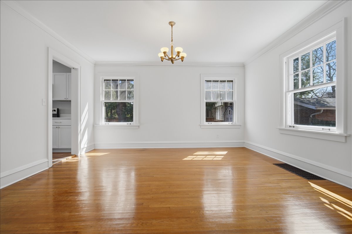 503 East Chestnut Street Bloomington, IL 61701 - Photo 8 of 24 a view of an empty room with window and wooden floor