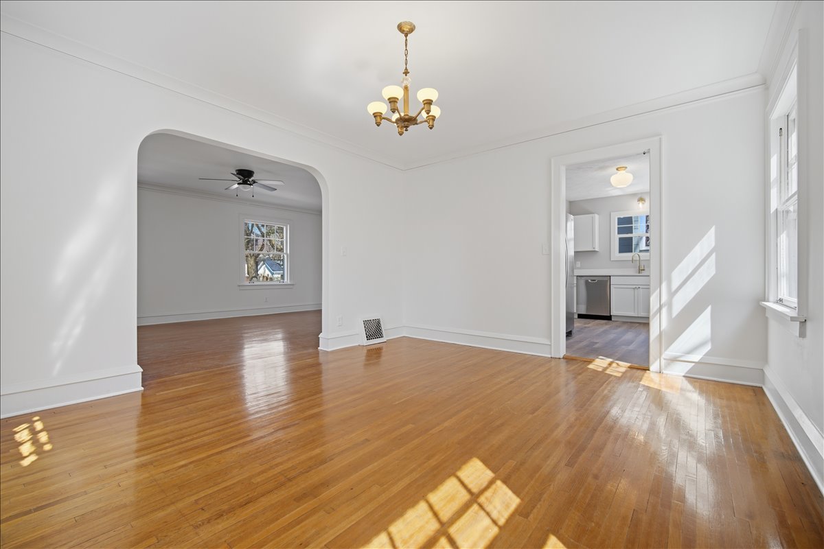 503 East Chestnut Street Bloomington, IL 61701 - Photo 9 of 24 a view of a livingroom with wooden floor and a chandelier