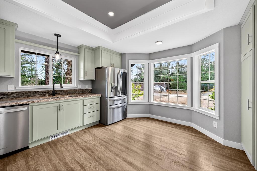 1149 Swanson Lane Colfax, CA 95713 - Photo 9 of 52 a kitchen with refrigerator a sink and dishwasher with wooden floor