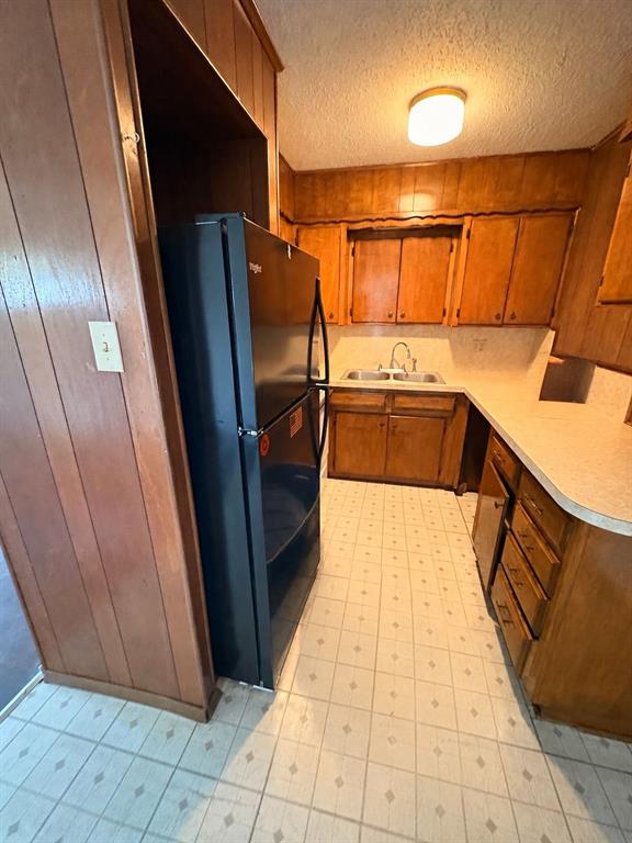1829 South Center Street Denison, TX 75021 - Photo 12 of 29 a kitchen with stainless steel appliances a refrigerator and microwave