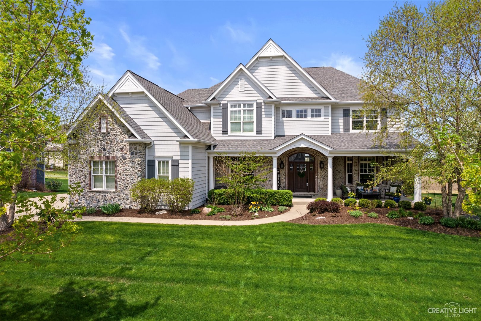 1749 Hunters Ridge Lane Sugar Grove, IL 60554 - Photo 2 of 45 a front view of a house with a garden and plants