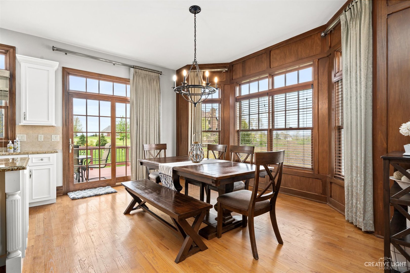 1749 Hunters Ridge Lane Sugar Grove, IL 60554 - Photo 8 of 45 a dining room with wooden floor a chandelier a wooden table and chairs
