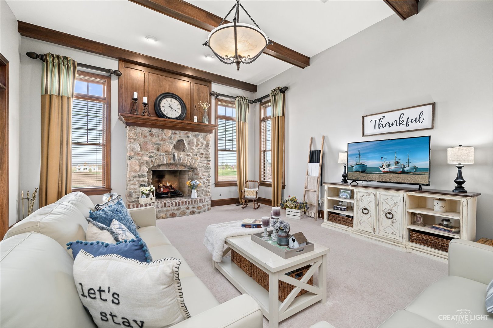 1749 Hunters Ridge Lane Sugar Grove, IL 60554 - Photo 10 of 45 a living room with furniture a fireplace and a flat screen tv