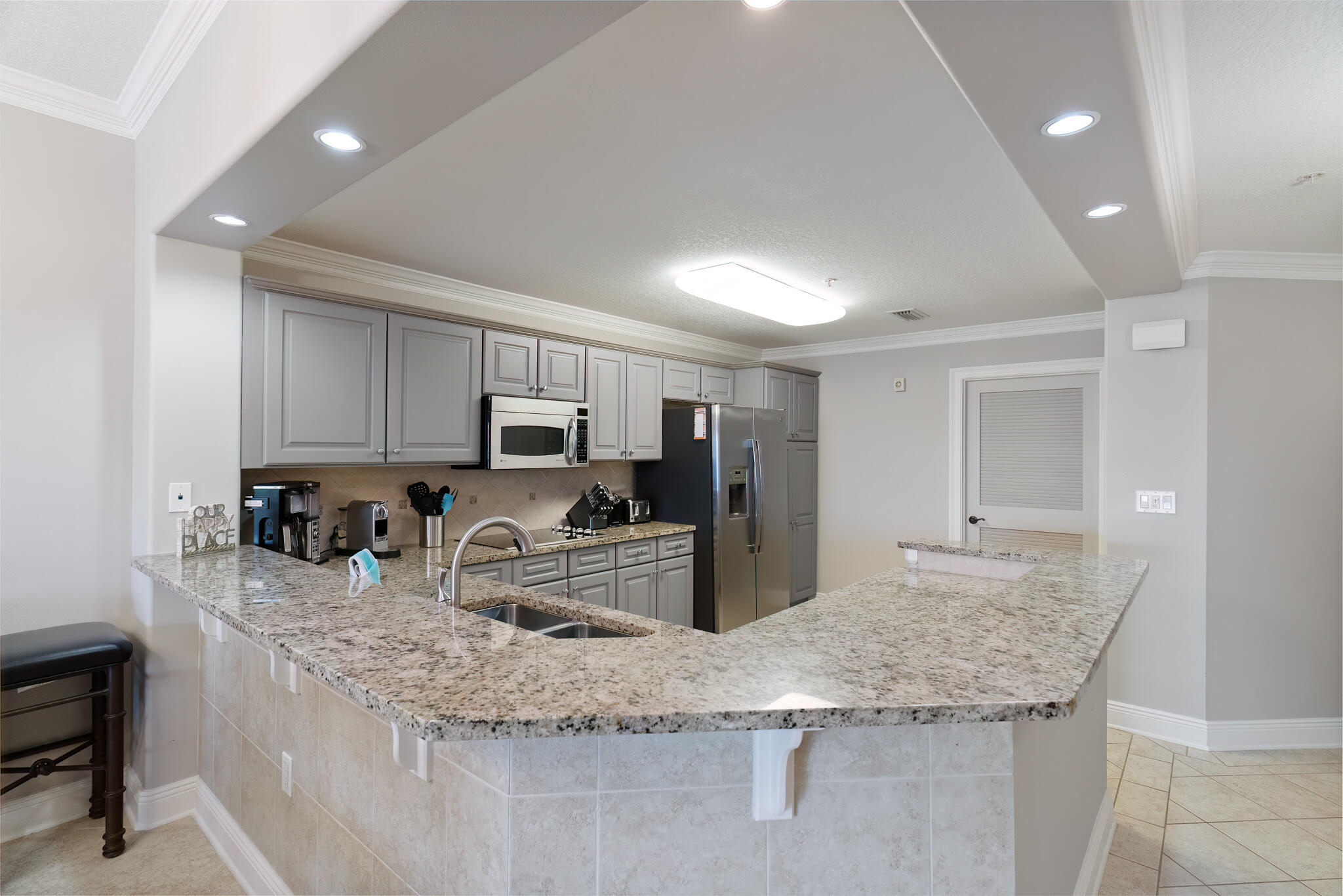 770 Harbor Boulevard, Unit 7E Destin, FL 32541 - Photo 13 of 50 a kitchen with granite countertop a sink a counter top space cabinets and stainless steel appliances