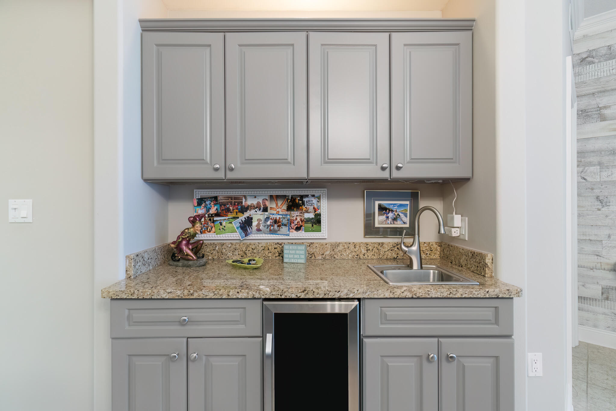 770 Harbor Boulevard, Unit 7E Destin, FL 32541 - Photo 9 of 50 a kitchen with granite countertop white cabinets and sink