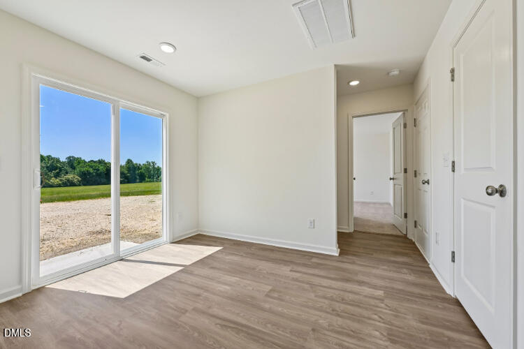 10955 Lancaster Store Road Castalia, NC 27816 - Photo 10 of 20 an empty room with wooden floor and windows