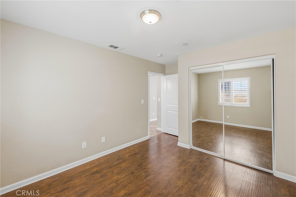 956 West Tibbot Street Rialto, CA 92377 - Photo 8 of 37 an empty room with wooden floor and windows
