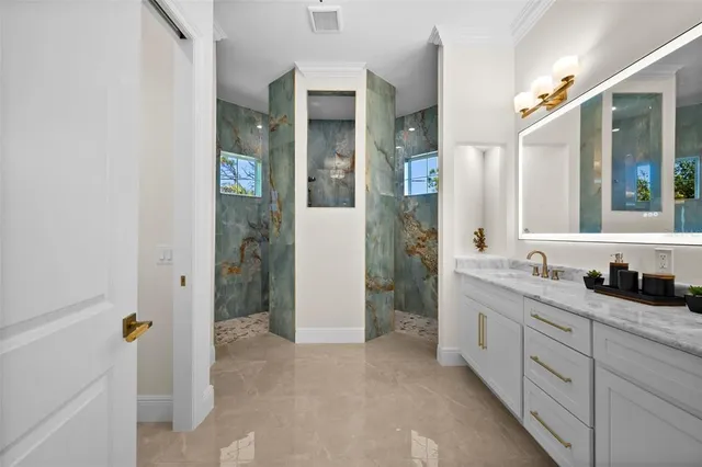 a spacious bathroom with a granite countertop sink mirror and shower