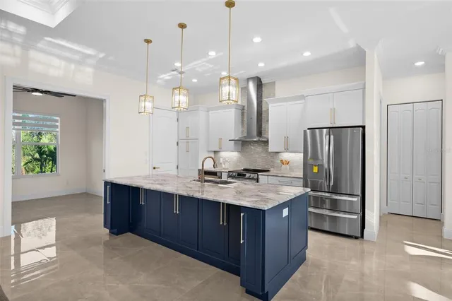 a kitchen with kitchen island a counter top space stainless steel appliances and a counter top space