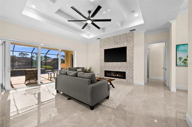 a living room with furniture a fireplace and a flat screen tv