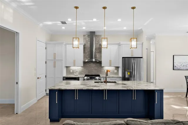 a kitchen with a refrigerator a sink and wooden cabinets