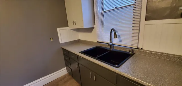 a kitchen with a sink and cabinets