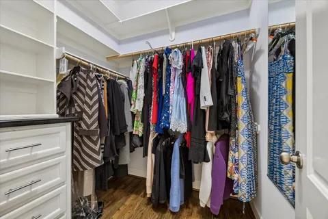 a view of walk in closet with clothes